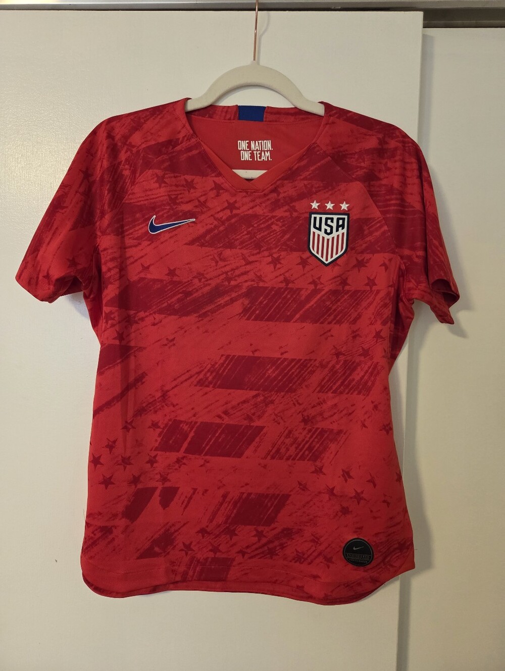 Nike USA women's 2019 World Cup away jersey in red with blue accents.